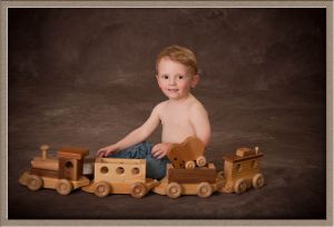 Portrait Photography of Little Boy and Toy Train Set